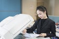 Asian woman secretary using copy machine Royalty Free Stock Photo
