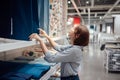 An Asian woman is selecting fabric and textile at the mall