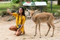 Asian woman selfie with Eld`s deer Royalty Free Stock Photo