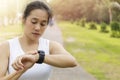 Asian Woman setting up the fitness smart watch for running. young women checking watch device. Women set smart watch before