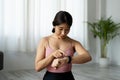 Asian woman setting up the fitness smart watch for workout fitness at home Royalty Free Stock Photo