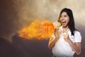 Asian Woman Shouting Megaphone On Fire Royalty Free Stock Photo