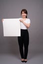 Asian woman showing empty white board with copyspace Royalty Free Stock Photo