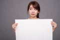 Asian woman showing empty white board with copyspace Royalty Free Stock Photo