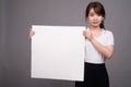 Asian woman showing empty white board with copyspace Royalty Free Stock Photo