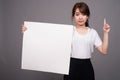 Asian woman showing empty white board with copyspace Royalty Free Stock Photo