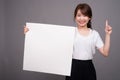 Asian woman showing empty white board with copyspace Royalty Free Stock Photo