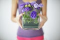 Asian Woman showing a pot of roses at home