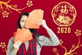 Asian woman showing red envelopes for chinese new year.chinese text happy new year 2020 Royalty Free Stock Photo