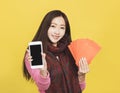 Asian woman showing red envelpoe and mobile phone screen,  celebrating chinese new year concept Royalty Free Stock Photo
