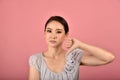 Asian woman showing thumb down gesture, Grumpy dissatisfied annoyed unhappy face expression