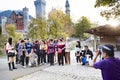 Asian Woman showing victory for photo in front of castle