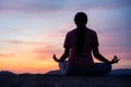 Asian  woman sit  lotus yoga position at sunset . Practicing yoga makes meditation for healthy breathing  and relaxation Royalty Free Stock Photo