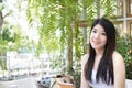 Asian woman sit at outdoor cafe. young female adult hold digital Royalty Free Stock Photo