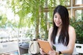 Asian woman sit at outdoor cafe. young female adult use digital Royalty Free Stock Photo