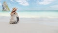 Asian woman sitting on the beach looking at the amazing sea and enjoying with beautiful nature in her vacation. Royalty Free Stock Photo