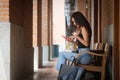 Asian woman sitting on the bench in the city after shopping Royalty Free Stock Photo