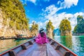 Asian woman sitting on boat in Ratchaprapha dam Khao sok national park at suratthani,Thailand Royalty Free Stock Photo