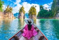 Asian woman sitting on boat in Ratchaprapha dam Khao sok national park at suratthani,Thailand Royalty Free Stock Photo