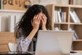 Asian woman sitting at desk in front of laptop stressed out face and headache shows her stressful  with work from home office. Royalty Free Stock Photo