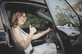 Asian woman sitting on driver seat in suv car sigh good tumb