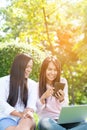 Asian woman sitting green park using laptop computer. Woman working on laptop happy entrepreneur business using notebook with Royalty Free Stock Photo