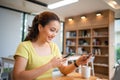 Asian woman sitting and holding credit card for online shopping by laptop and smart phone at home Royalty Free Stock Photo