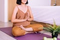 Asian woman sitting practicing doing yoga meditation in bedroom,Workout exercise after waking up in morning,Healthy and lifestyle Royalty Free Stock Photo