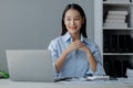 Asian woman sitting in startup company office, businesswoman, executive and investor in business and stocks, management of young Royalty Free Stock Photo