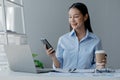 Asian woman sitting in startup company office, businesswoman, executive and investor in business and stocks, management of young Royalty Free Stock Photo