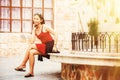 Asian woman sitting on Stone bench in city Royalty Free Stock Photo