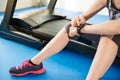 Asian woman sitting on treadmill. smartwatch check pulse rate Royalty Free Stock Photo