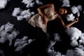 Asian Woman sleep on Scatter Fake Cloud at Night Sky Time Royalty Free Stock Photo