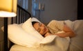 Asian woman sleeping on the bed in her bedroom at home Royalty Free Stock Photo