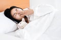 Asian woman sleeping with cat having allergic to cat fur and sneezing in bed Royalty Free Stock Photo