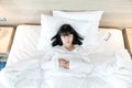 Asian woman sleeps on white bed after exhausted and tried all day