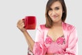 Woman holding a red cup of coffee in the morning Royalty Free Stock Photo