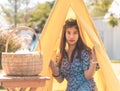 Asian woman in a small camping picnic cover in a public park for healthy natural lifestyle concept