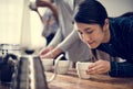 Asian woman smelling coffee aroma in a cup
