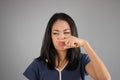 Asian woman smells something. Royalty Free Stock Photo