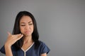 Asian woman smells something. Royalty Free Stock Photo