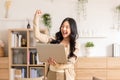Asian woman is smiling and expressing happy feeling on the computer laptop screen. young female got good news and show cheerful Royalty Free Stock Photo