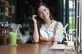 Asian women smiling and happy Relaxing with green tea in a coffee shop Royalty Free Stock Photo