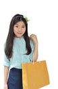 Asian woman smiling and holding shopping bag