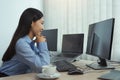 Asian woman software developers sitting in front of computers looking at computer codes on the screen Royalty Free Stock Photo
