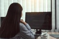 Asian woman software developers sitting in front of computers looking at computer codes on the screen Royalty Free Stock Photo