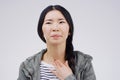 Asian woman, sore throat and virus in pain, allergies or bacteria against a white studio background. Sick Japanese Royalty Free Stock Photo