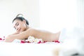 Asian woman on spa bed with fragrant flowers Royalty Free Stock Photo
