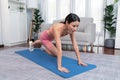 Asian woman in sportswear doing burpee on exercising mat. Vigorous Royalty Free Stock Photo