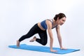 Asian woman in sportswear doing burpee on exercising mat. Vigorous Royalty Free Stock Photo